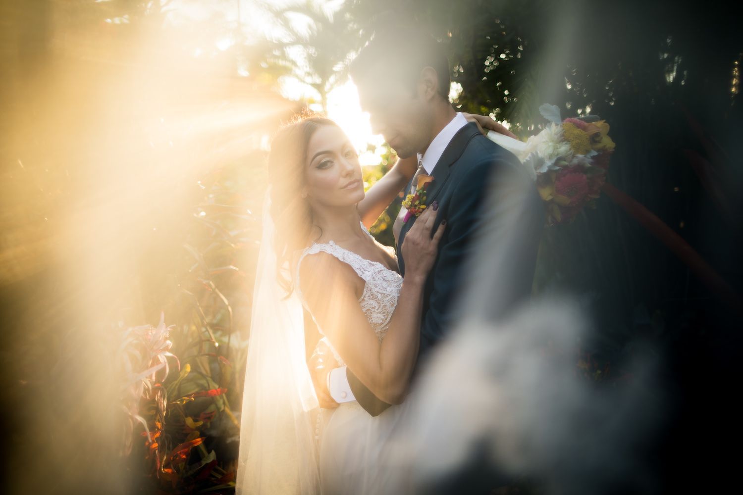 Candid emotional moment between bride and groom who have forgotten the camera is there