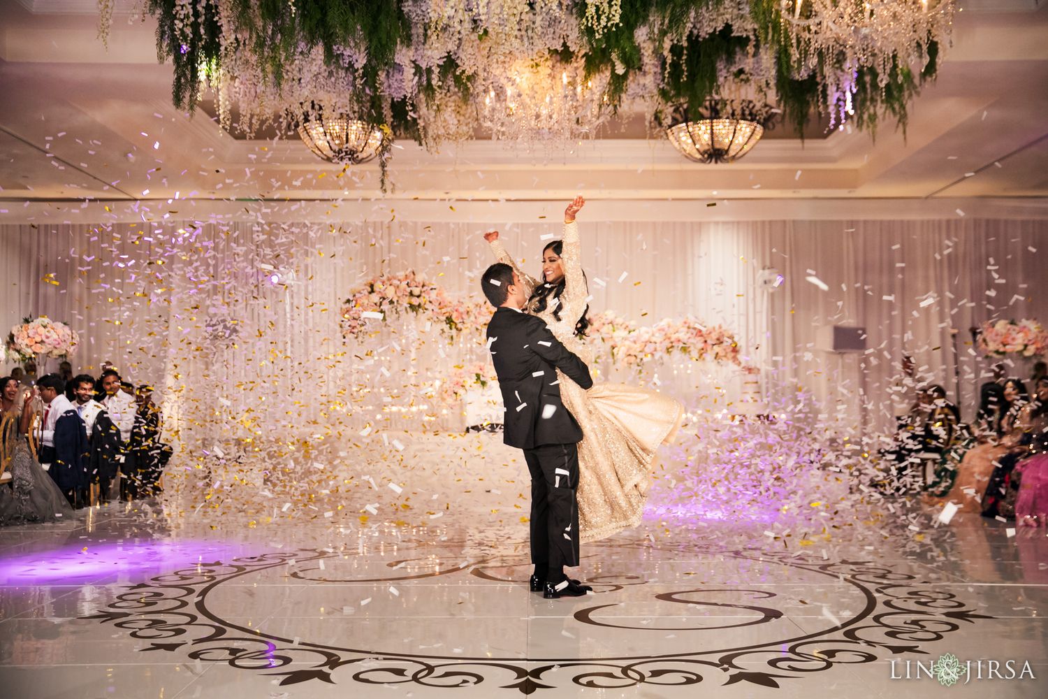 Wedding reception in a large ballroom with expertly managed mixed lighting