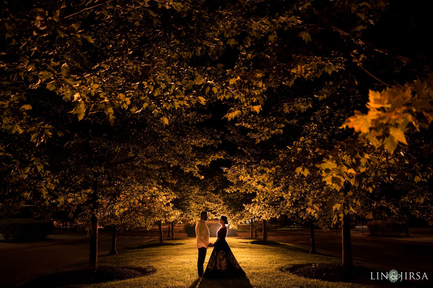 Bride and groom reconnecting in a quiet moment with the night sky behind them