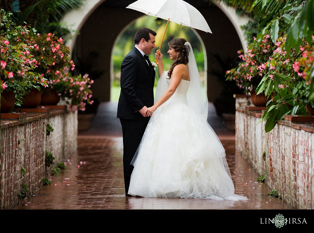 Four Seasons Bitlmore Santa Barbara Wedding Photography rain kissing