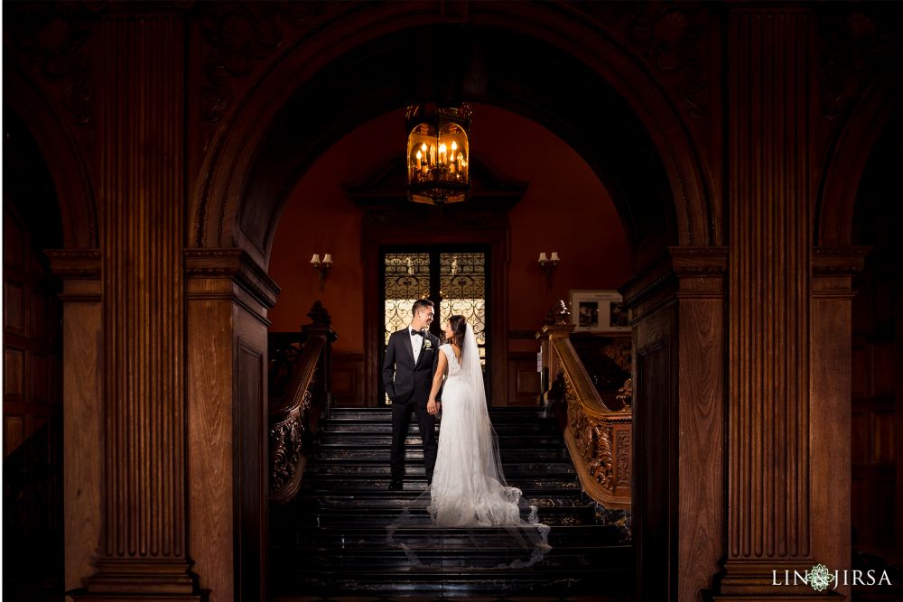 Lin & Jirsa photographing a couple getting married in the foyer of the wedding venue: Greystone Mansion in Beverly Hills