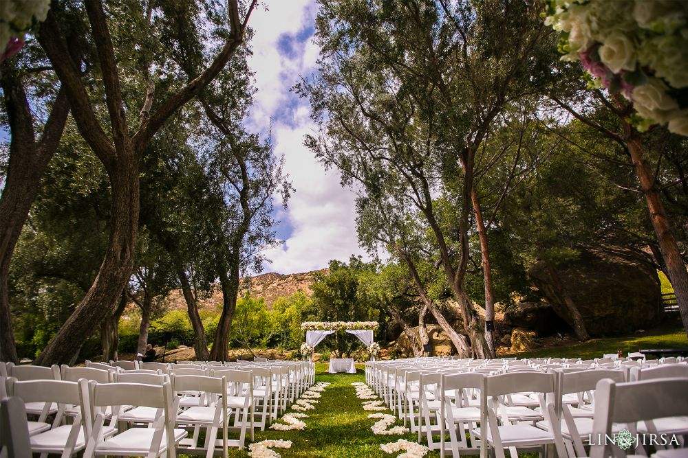 A photo of the stunning venue called Hummingbird's Nest with white chairs and a white wedding canopy in the background