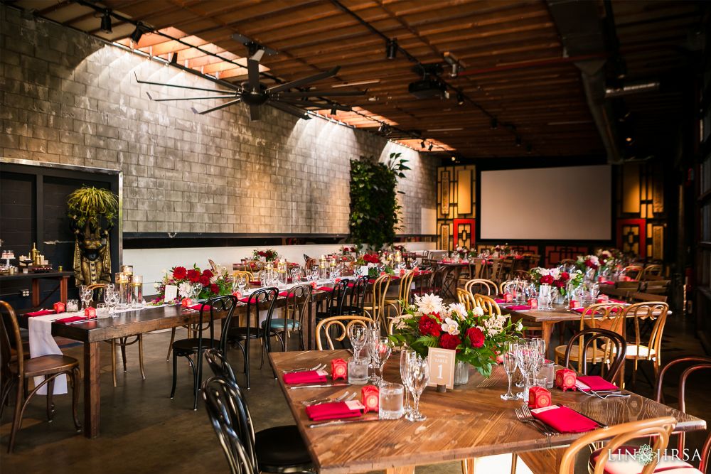 Los Angeles wedding venue: SmogShoppe decorated, according to Chinese wedding traditions with rich red, pink and white hues, set against a rustic earth background
