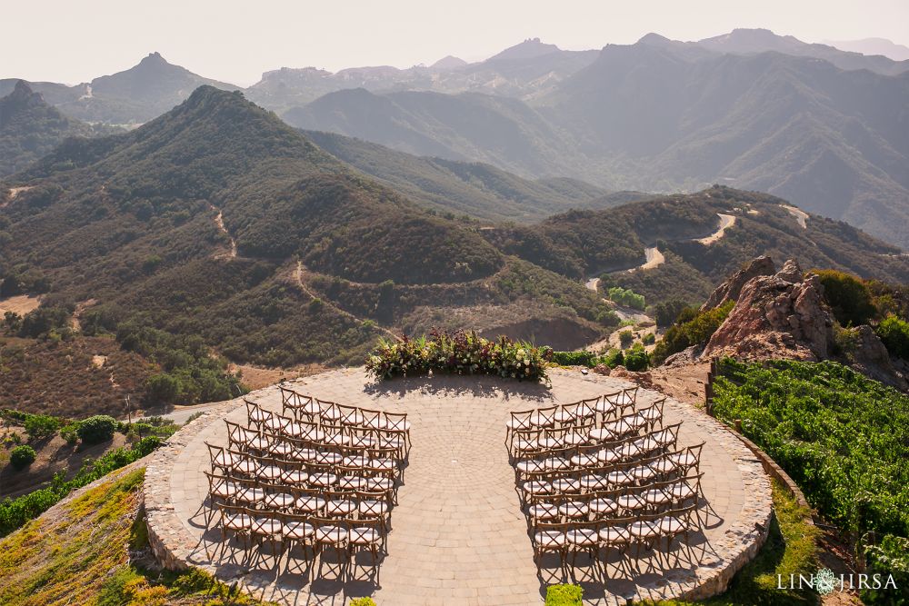 A circular platform with chairs arranged neatly in a semicircle, facing the mountains and the wedding altar at Malibu Rocky Oaks in Los Angeles, California