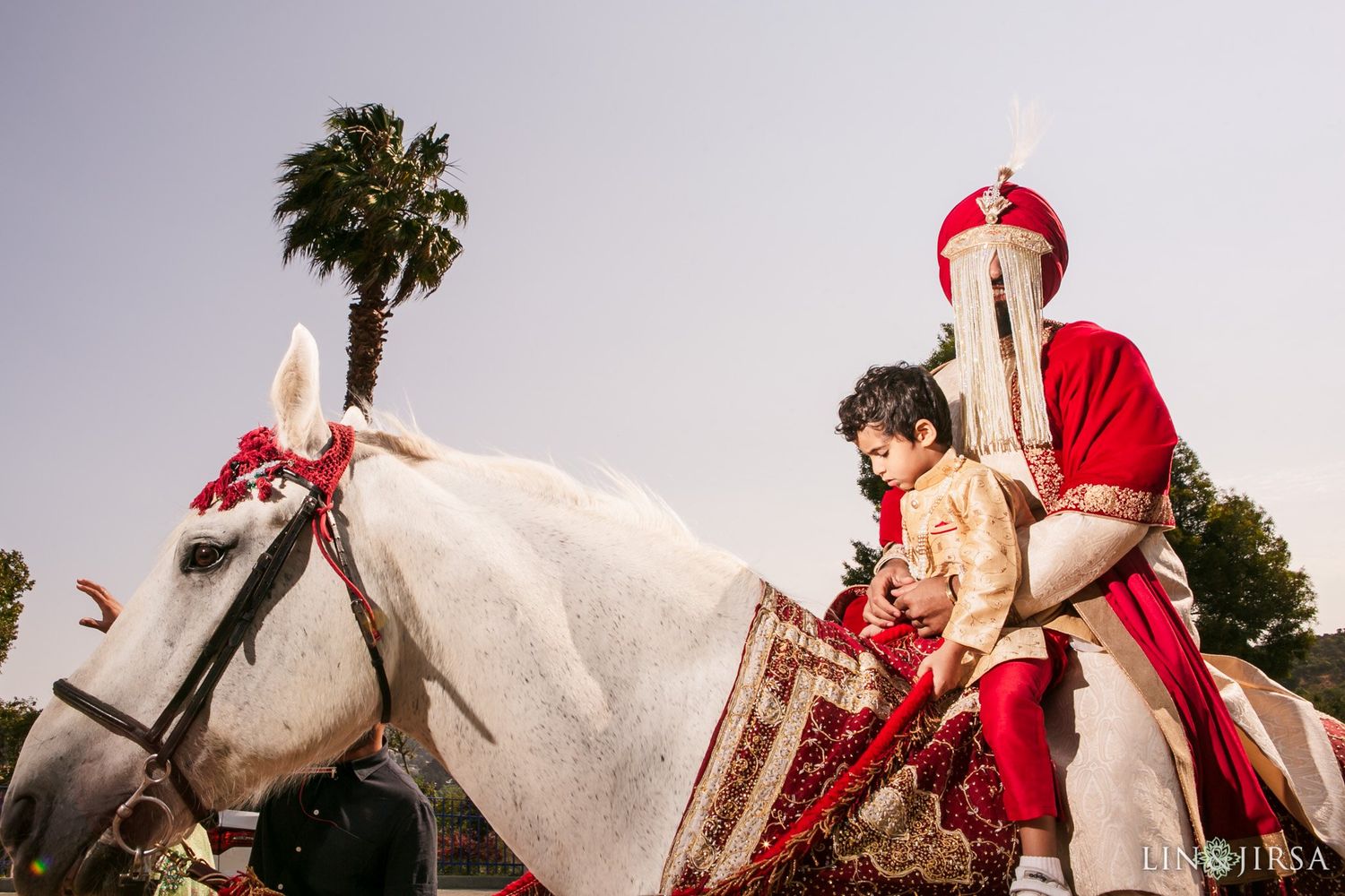 Wide shot of the Baraat procession capturing the full movement and joy of the groom's arrival