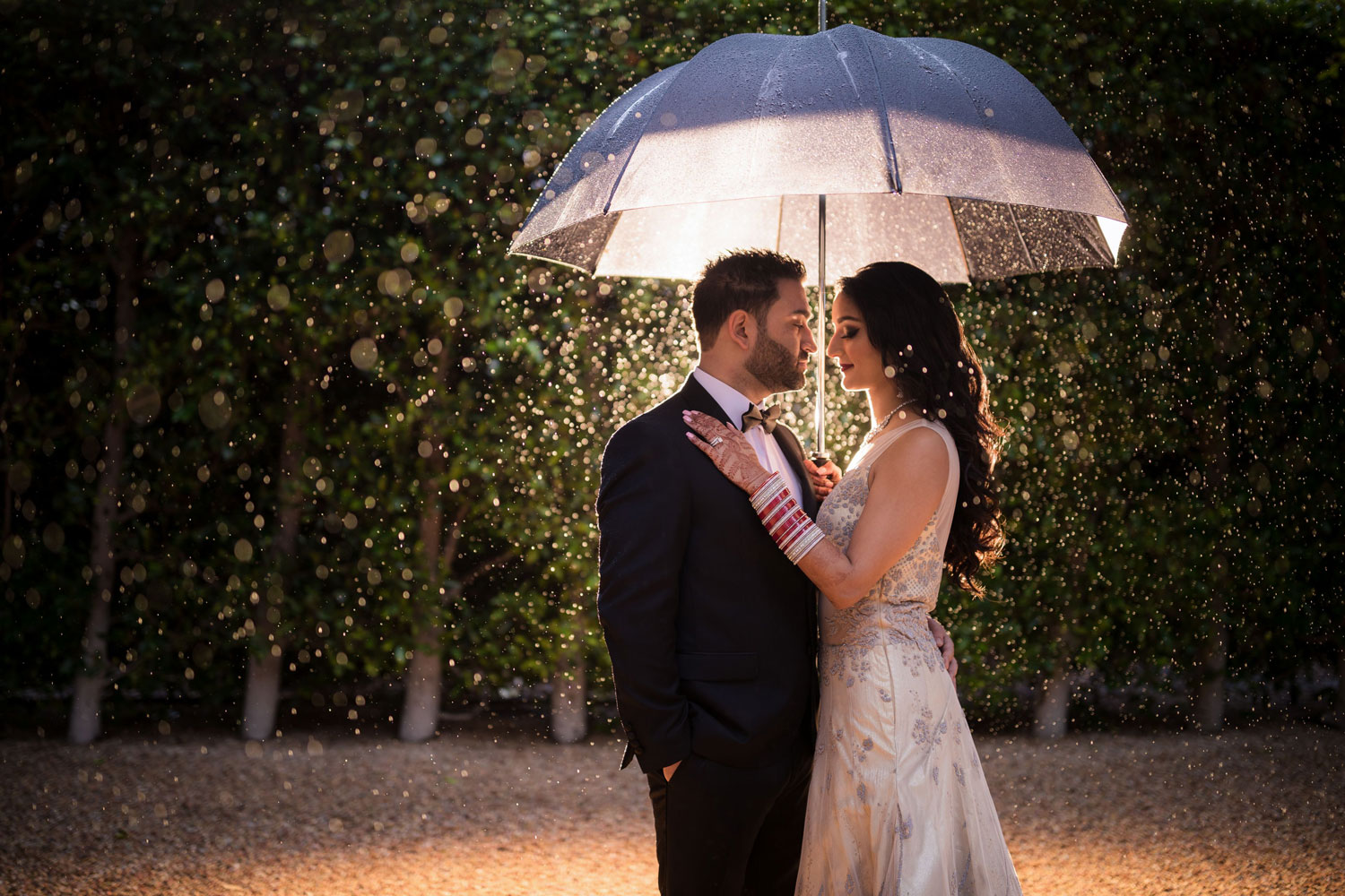 Creative nighttime wedding portrait with the Fairmont San Francisco as a dramatic backdrop