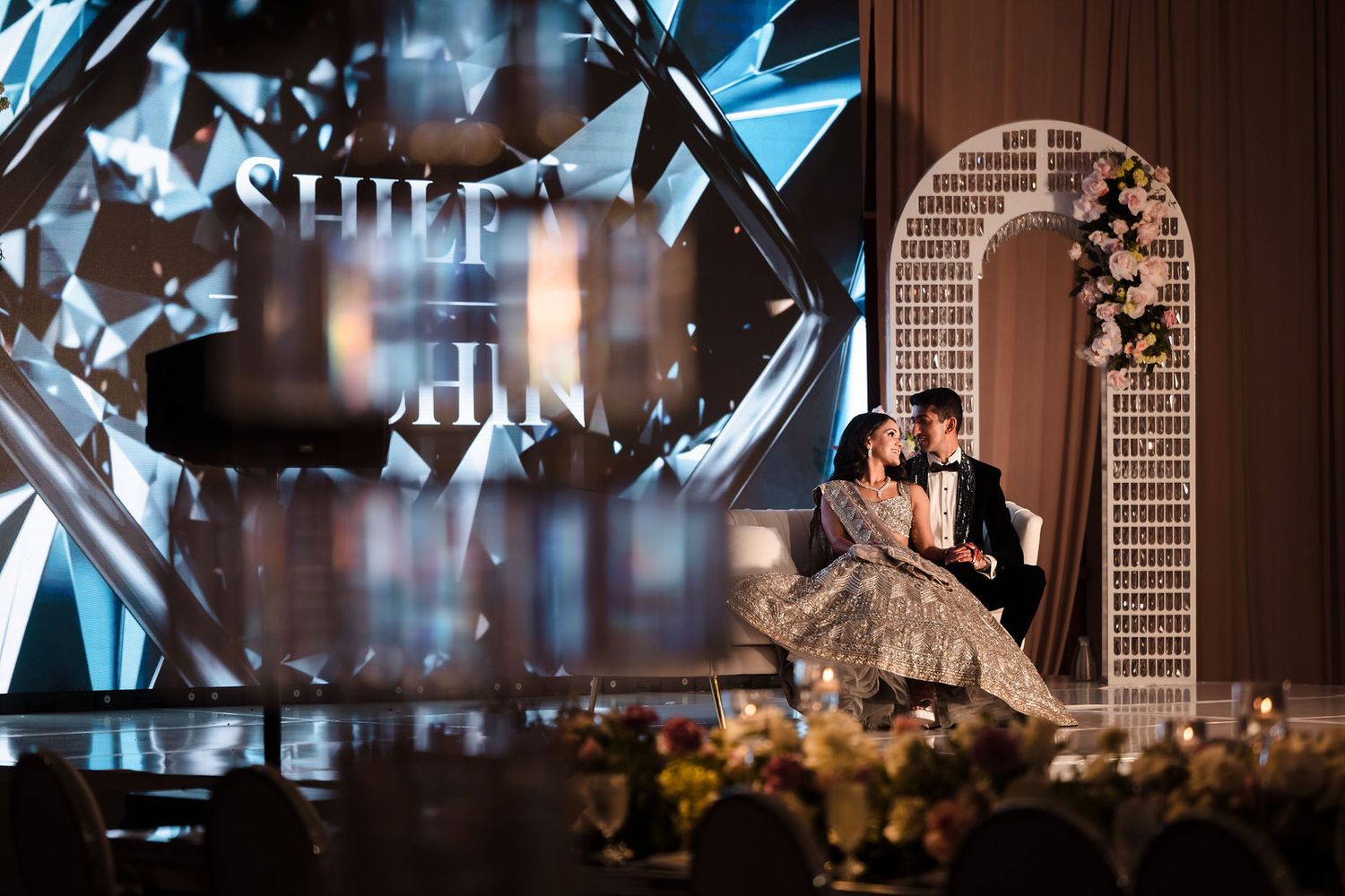 Grandmother watching the couple from her seat during the first dance at the reception