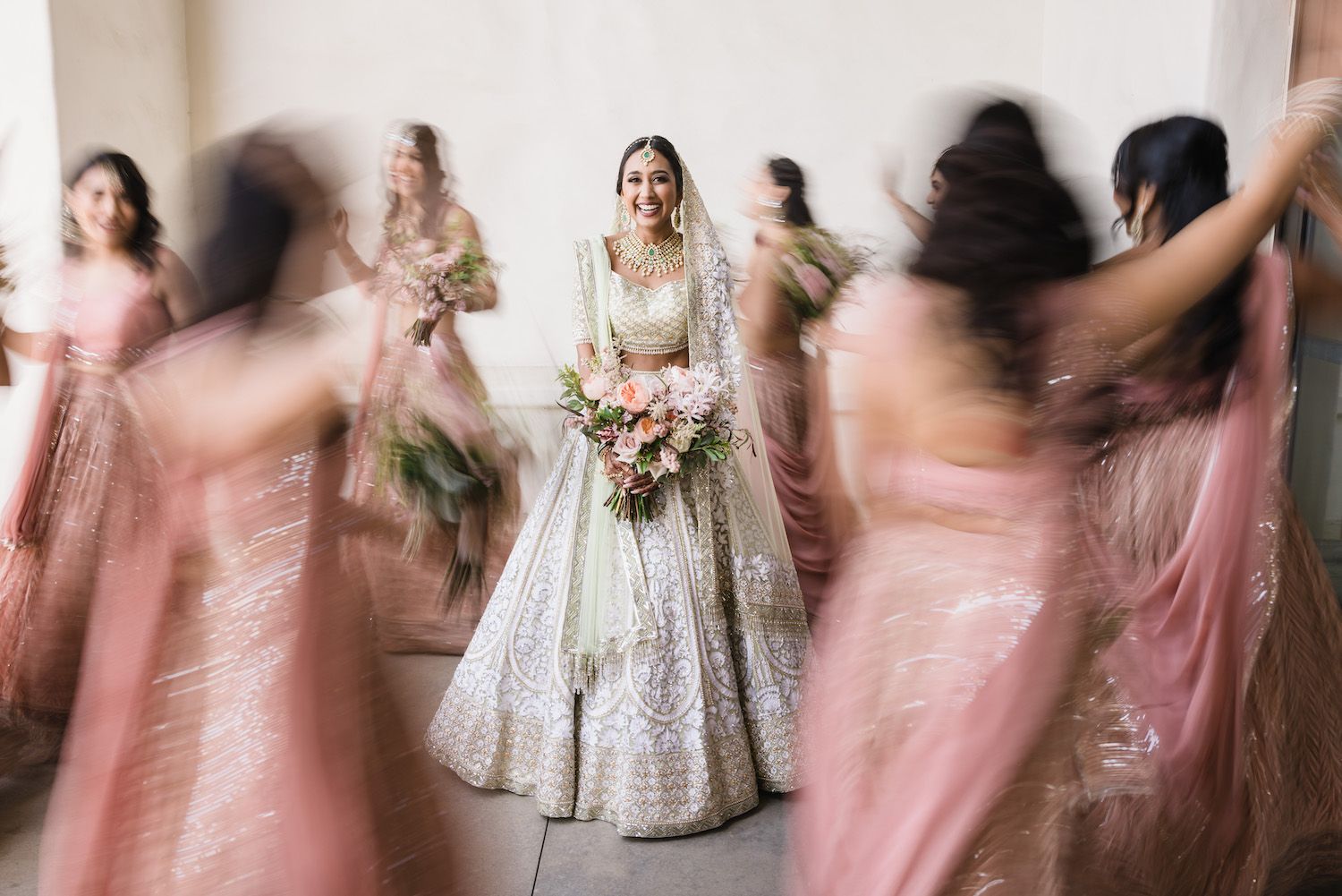 Bridal party in a dynamic editorial-style portrait that feels candid rather than posed